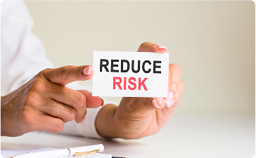 Risk Management, Steady Growth - Hands holding REDUCE RISK card